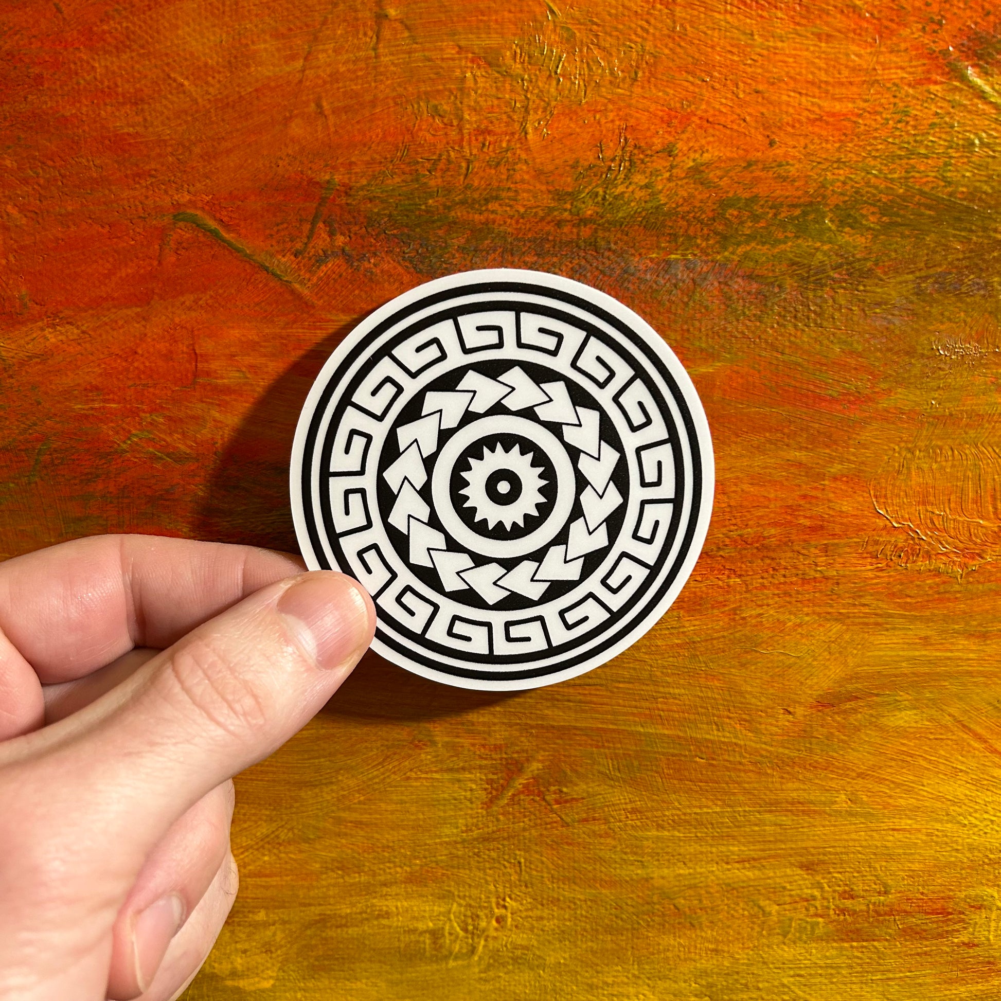 A round black and white Polynesian sticker with bold contrasting patterns swirling around in an abstract symphony. Polynesian symbols bring this design to life with its specific meaning.