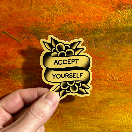 A light brown sepia coloured sticker saying accept yourself in banners and adorned by 2 water Lilly flowers