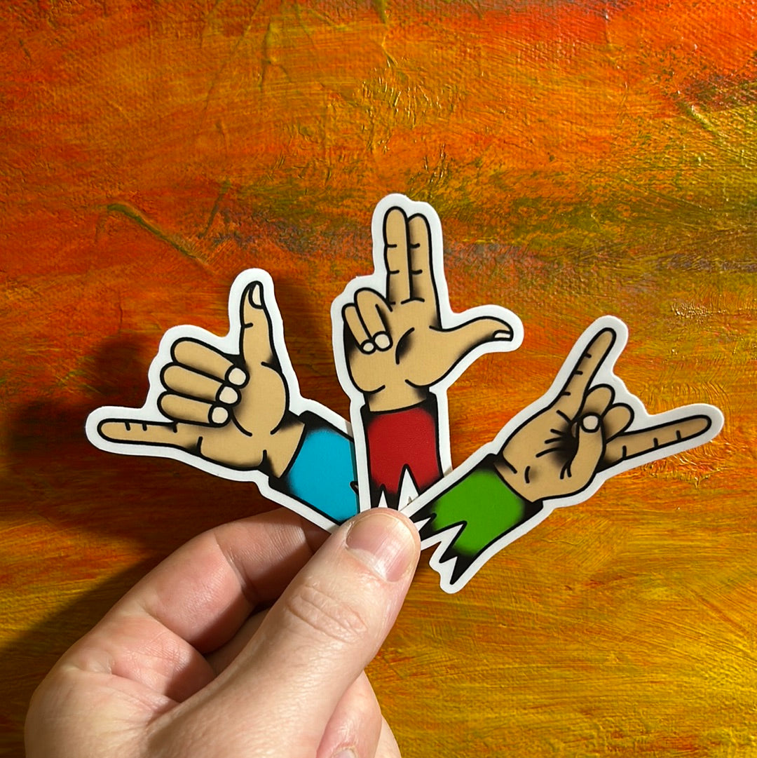 3 different stickers of illustrations of hand gestures. One hand has the Shaka, another hand has two index fingers pointing like a gun and the other hand is pointing index and pinky fingers for a rock n roll sign.