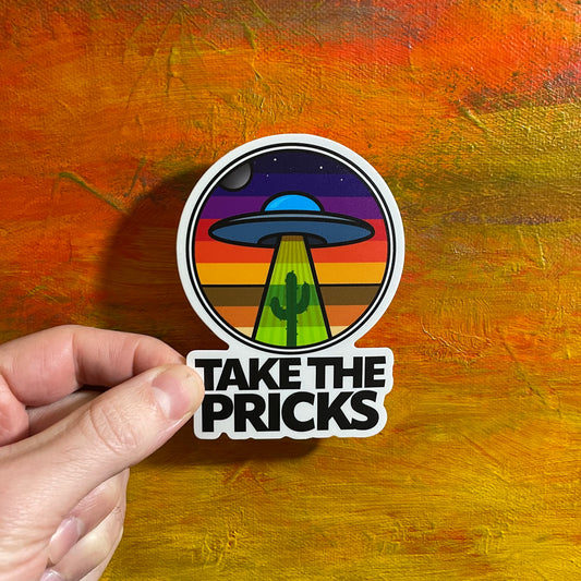 A colorful die cut sticker of an illustrative UFO UAP beaming down to a cactus. The background is a gradient of sky colours. Below the scene is the saying “Take the pricks”.