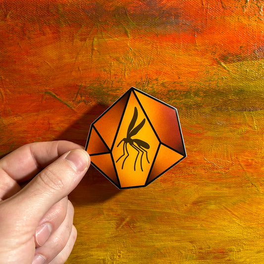 An illustrative die cut sticker of a yellow orange red amber gem with a black mosquito inside of it. It is referencing the gem found in the movie Jurassic Park.