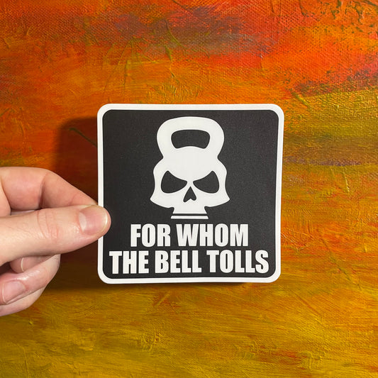 Black square sticker with a white illustrative kettlebell skull and bold capital letters underneath spelling “FOR WHOM THE BELL TOLLS”.